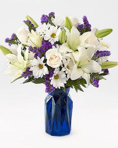 Gift your friends and family the freshest and most beautiful bouquet of lilies, roses and statice. Perfect for complementing any message you want to send, our Beyond Blue Bouquet features a deep blue vase and a gorgeous array of white and purple blooms.

STANDARD
C Quantity Color Description
3 Ivory 50 cm Standard Rose - Escimo
2 White LA Hybrid Lily
5 White Daisy Pom
3 Purple Filler - Sinuata Statice
3 Green Green - Leather Leaf

DELUXE

C Quantity Color Description
5 Ivory 50 cm Standard Rose - Escimo
3 White LA Hybrid Lily
5 White Daisy Pom
4 Purple Filler - Sinuata Statice
3 Green Green - Leather Leaf

PREMIUM

C Quantity Color Description
6 Ivory 50 cm Standard Rose - Escimo
4 White LA Hybrid Lily
5 White Daisy Pom
4 Purple Filler - Sinuata Statice
3 Green Green - Leather Leaf