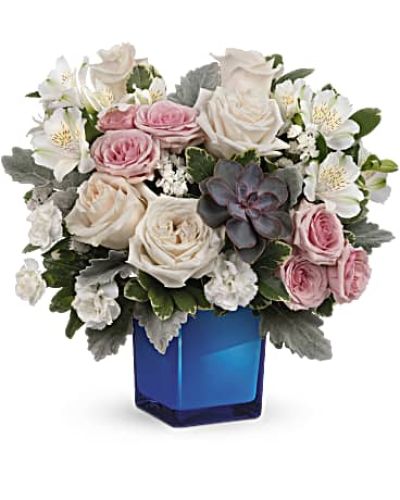 <div id="mark-3" class="m-pdp-tabs-marketing-description">Soft as a whisper, this enchanting bouquet of cream and pink roses looks oh-so-lovely in a glass cube that later becomes a comely candleholder.</div>
<p>&nbsp;</p>
<div id="desc-3">Crème roses, pink spray roses, white alstroemeria and miniature white carnations are arranged with variegated pittosporum, dusy miller, white sinuata statice and a large, potted green echeveria succulent.</div>