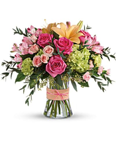<div id="mark-3" class="m-pdp-tabs-marketing-description">Put a spring in their step with this beautifully blushing bouquet of hot pink roses, soft peach lilies and fresh green hydrangea. Arranged in a graceful vase tied with a charming bow, it's a chic treat for any occasion!</div>
<div id="desc-3">
<ul>
 	<li>This sweet arrangement features green hydrangea, hot pink roses, pink spray roses, peach asiatic lilies, pink alstroemeria, green carnations, pink miniature carnations, seeded eucalyptus, parvifolia eucalyptus, and lemon leaf.</li>
</ul>
</div>