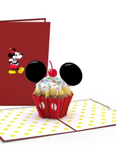 <p>A cheery Disney Mickey Mouse stands with his arms crossed on the red cover of this pop-up card, wearing a party hat. Upon opening, a delicious looking birthday cupcake appears. A red cupcake wrapper, colorful sprinkles, black mouse ears, and a cherry on top -- how cute! The inner panels feature a yellow polka dot pattern, adding to the overall magic and whimsy of this design.</p>
<p><strong>Inspiration for the Mickey Mouse Birthday Cupcake card:</strong><br />
Nothing is more magical than a birthday celebration! We want everyone to have both a sweet and classic way to wish the Disney fans you know a very happy birthday. Three cheers for the Mouseketeer in your life who loves sweet treats!</p>
<p><strong>Occasions for the Mickey Mouse Birthday Cupcake card:</strong><br />
All Disney fans alike will fall for this sugary birthday surprise. Send this pop-up card to your sibling as a nostalgic throwback to when you were kids. No matter the recipient, they're sure to have an extra sweet birthday celebration with this classic design.</p>
<p><strong>Size:</strong><br />
The Disney Mickey Mouse Birthday Cupcake pop-up card is 5 inches wide by 7 inches tall.</p>
<p><strong>Quantity:</strong><br />
One sprinkle-filled Lovepop with one blank envelope and the Lovepop Note, a little note card that slides away with your own personal touch.</p>