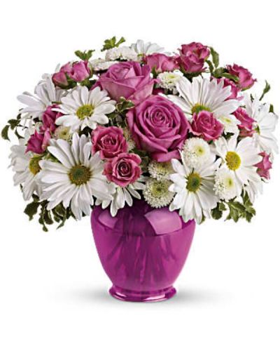 Make their spirits soar with a surprise bouquet of pink roses and white daisies in a dazzling fuchsia ginger jar. This classic vase, is not only beautiful, but beautifully affordable. They'll love it for years.
The lush bouquet includes pink roses, pink spray roses, white daisy spray chrysanthemums and white button spray chrysanthemums accented with fresh greenery.
