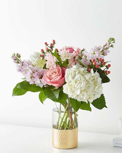 <p>Tickle them pink with this elegant arrangement of roses, alstroemeria, hypericum berries, and carnations set in a gold–dipped vase. As elegant as a string of pearls, add a touch of class to any room with roses and gerbera daisies.</p>
