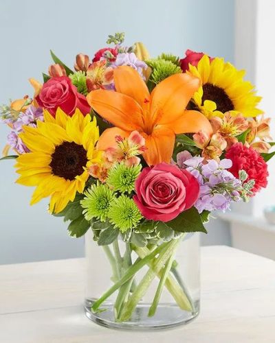 <p>Like a warm embrace, our vibrant flower bouquet delivers your sentiments to someone special. A rich gathering of yellow and orange blooms, with pops of bright pink and purple, it's more than a gift - it's a way to express how you feel inside.</p>