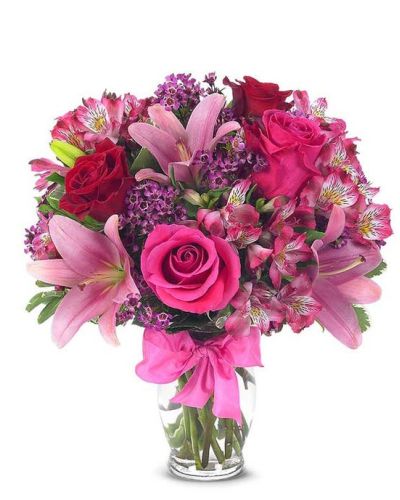 <p>This sweetly flirtatious combination of Asiatic lilies, waxflower, alstroemeria and roses makes a thoughtful gift they'll not soon forget. A pretty pink ribbon and clear fluted glass vase add to the romantic look.</p>