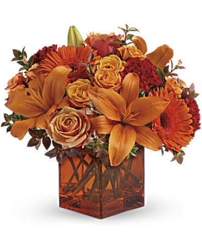 <div id="mark-3" class="m-pdp-tabs-marketing-description">Celebrate the wonder of a new day with warm, golden flowers. A modern orange glass vase is the foundation of this stunning, sun-bright bouquet that energizes any occasion.</div>
<del> </del>

&nbsp;
<ul>
 	<li>Orange gerbera daisies, orange roses and red mini carnations are accented with a spray of red huckleberry in an orange cube</li>
</ul>
<div id="desc-3">
<ul>
 	<li>vase.</li>
</ul>
</div>
&nbsp;
<ul>
 	<li></li>
</ul>
&nbsp;