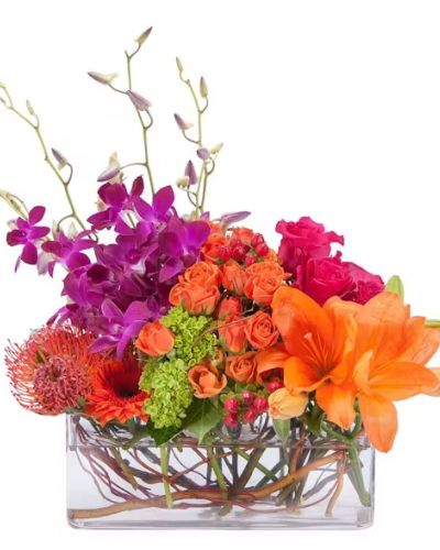 Groupings of premium blooms in a clear glass container combine to make this modern design.