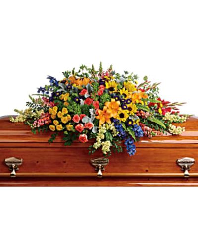 <div id="mark-1" class="m-pdp-tabs-marketing-description">Honor a bright, beautiful life with this colorful burst of hydrangea, roses, lilies and sunflowers that will add a rainbow of hope to the service.</div>
<div id="desc-1">
<ul>
 	<li>Green hydrangea, orange roses, yellow spray roses, orange asiatic lilies, red gladioli, large yellow sunflowers, blue delphinium, orange snapdragons, light yellow stock, purple matsumoto asters, and yellow button spray chrysanthemums are accented with green trick dianthus, blue eryngium, bupleurum, dusty miller and greenery.</li>
</ul>
</div>