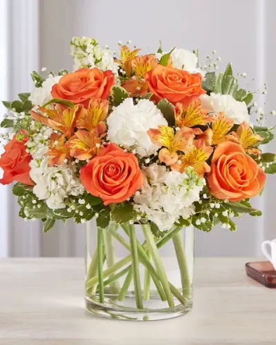 The sweet citrus shades in our charming bouquet bring your sentiments to life. Loosely gathered inside a clear cylinder vase, the mix of vibrant orange and creamy white blooms makes special milestones and everyday moments even more memorable.